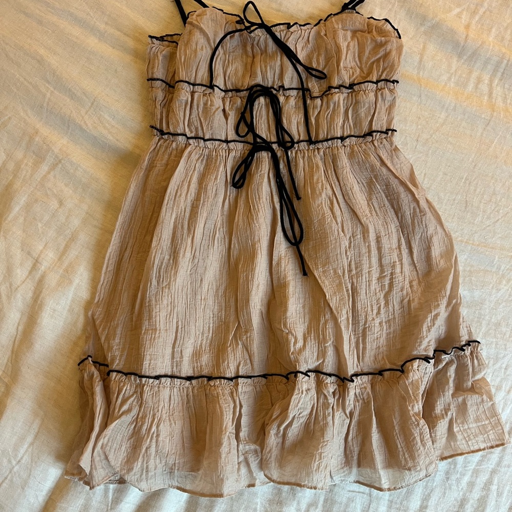 Beige Dress wwith Black Bows and Accents